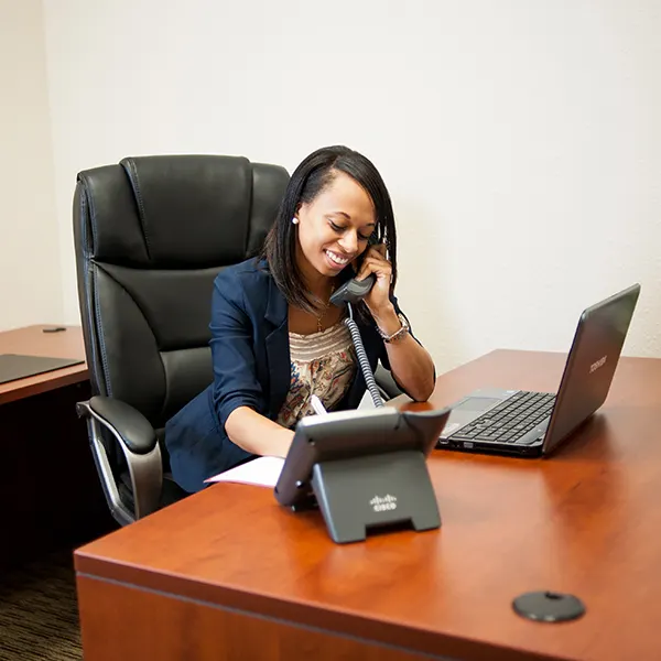Woman talking on the phone in a private office