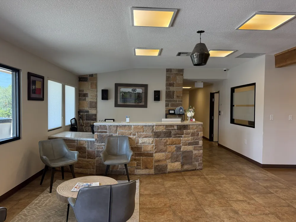 Lobby seating and stone reception desk at Heritage Office Suites Georgetown