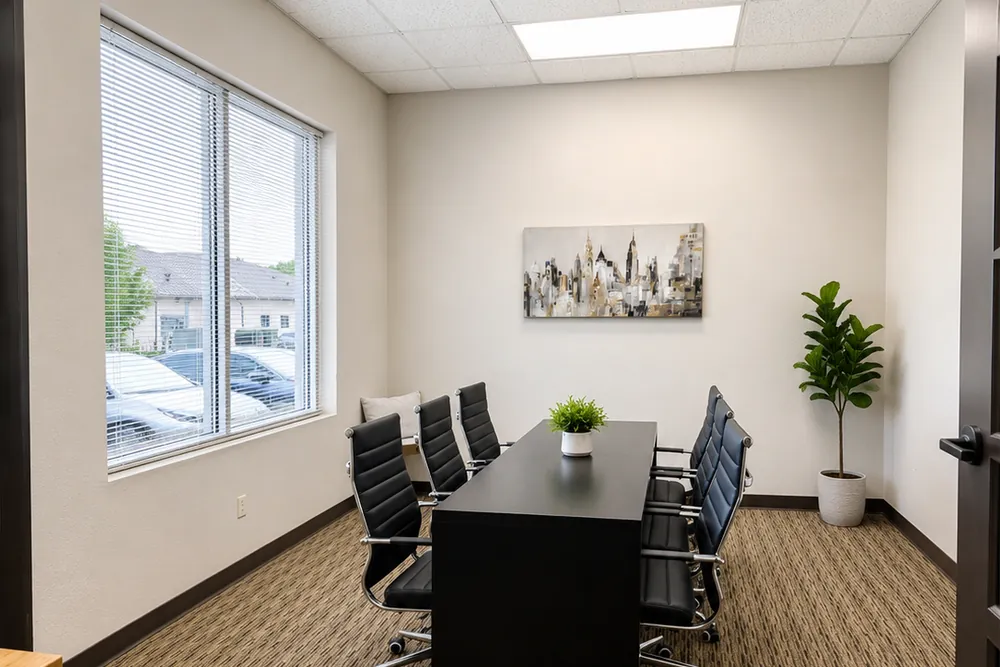 Team office with a meeting table and chairs at Heritage Office Suites Round Rock